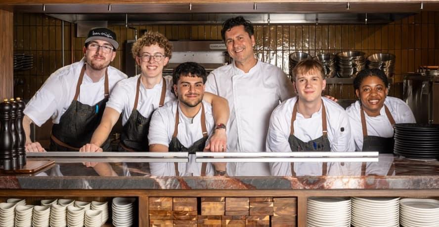 Bar Origin Toronto chef Claudio Aprile plating shareable dishes in his new restaurant dining room