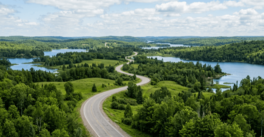 Scenic open road winding through Ontario countryside, one of the best road trips from Toronto